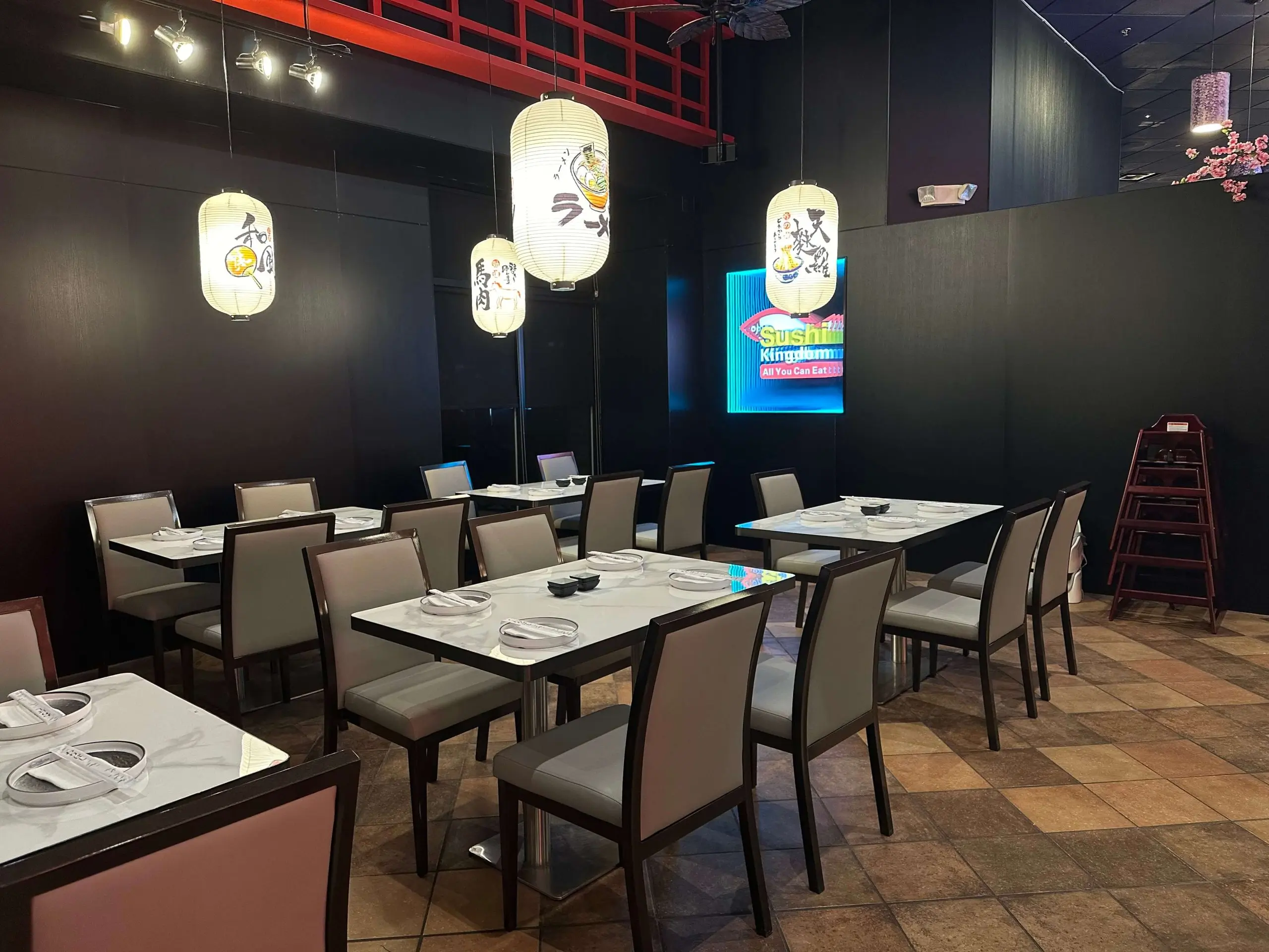 Cozy dining area with dark walls and Japanese - themed lanterns at Sushi Kingdom, a Japanese Restaurant in Savannah