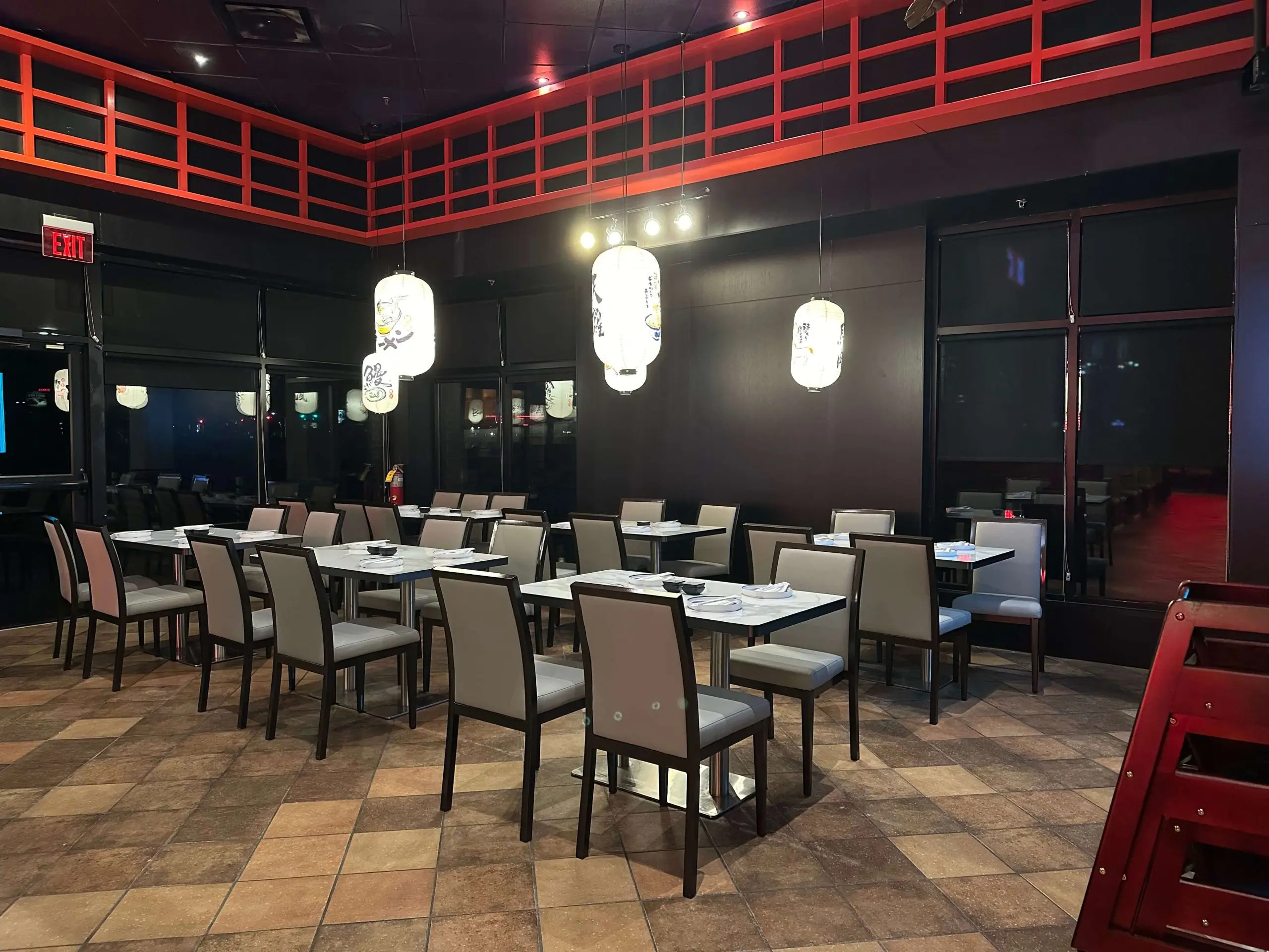 Spacious dining area with red accents and Japanese decor at Sushi Kingdom, a Japanese Restaurant in Savannah